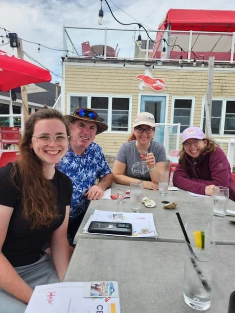 A group eating fresh oysters at an outdoor table