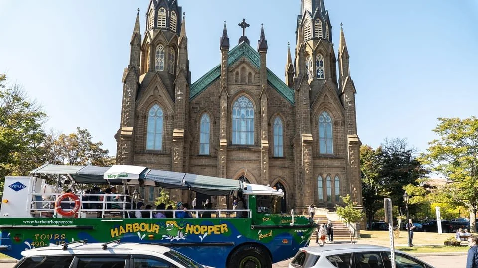An amphibious tour vehicle passing St. Dunstan's Basilica in Charlottetown